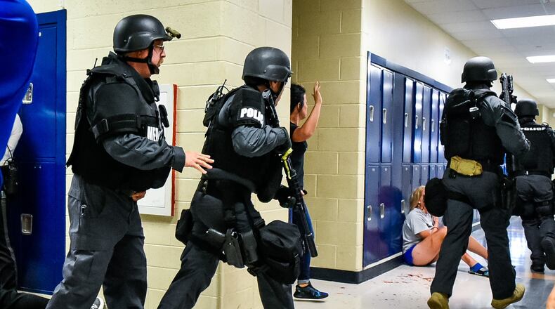 Hamilton Police Department, Hamilton Fire department and other local agencies participated in a SWAT Training drill in June with Hamilton City School District at Hamilton High School. NICK GRAHAM/STAFF