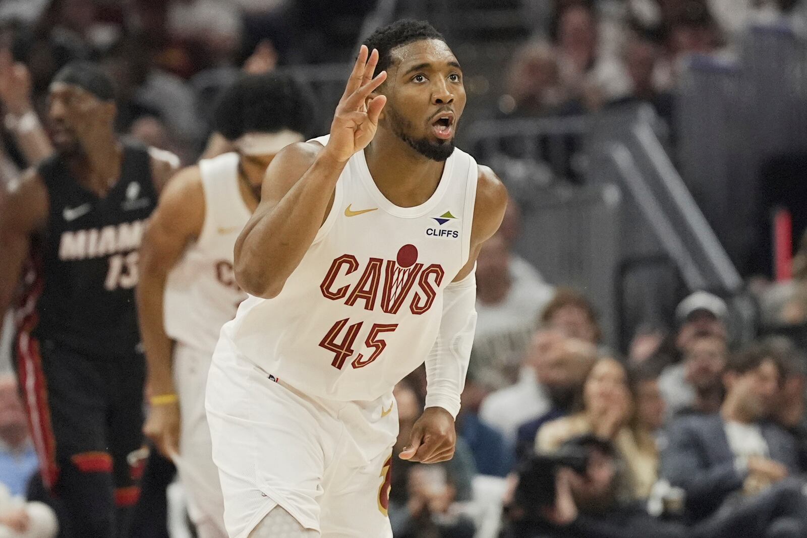 Cleveland Cavaliers guard Donovan Mitchell (45) gestures after a three point basket in the first half in Game 2 of an NBA first-round playoff series against the Miami Heat, Wednesday, April 23, 2025, in Cleveland. (AP Photo/Sue Ogrocki)