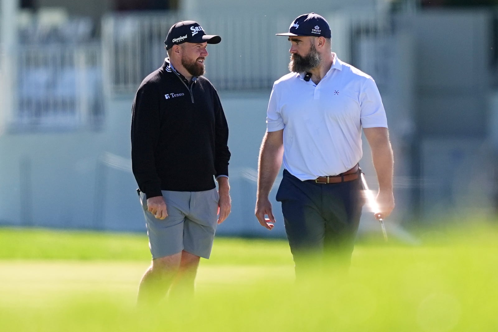 Former Philadelphia Eagles football player Jason Kelce, right, and Shane Lowry, of Ireland, talk on the 18th hole during a pro-am before the Truist Championship golf tournament at the Philadelphia Cricket Club, Wednesday, May 7, 2025, in Flourtown, Pa. (AP Photo/Matt Rourke)