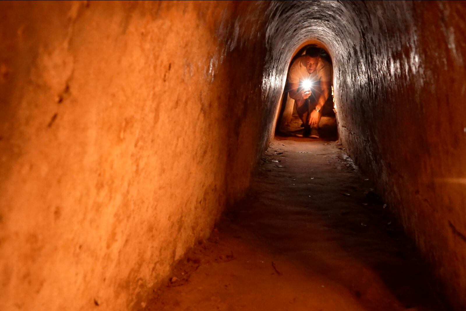 A tourist moves in a narrow tunnel passage in the relic site of Cu Chi tunnels in Ho Chi Minh City, Vietnam, Feb. 23, 2025. (AP Photo/Hau Dinh)