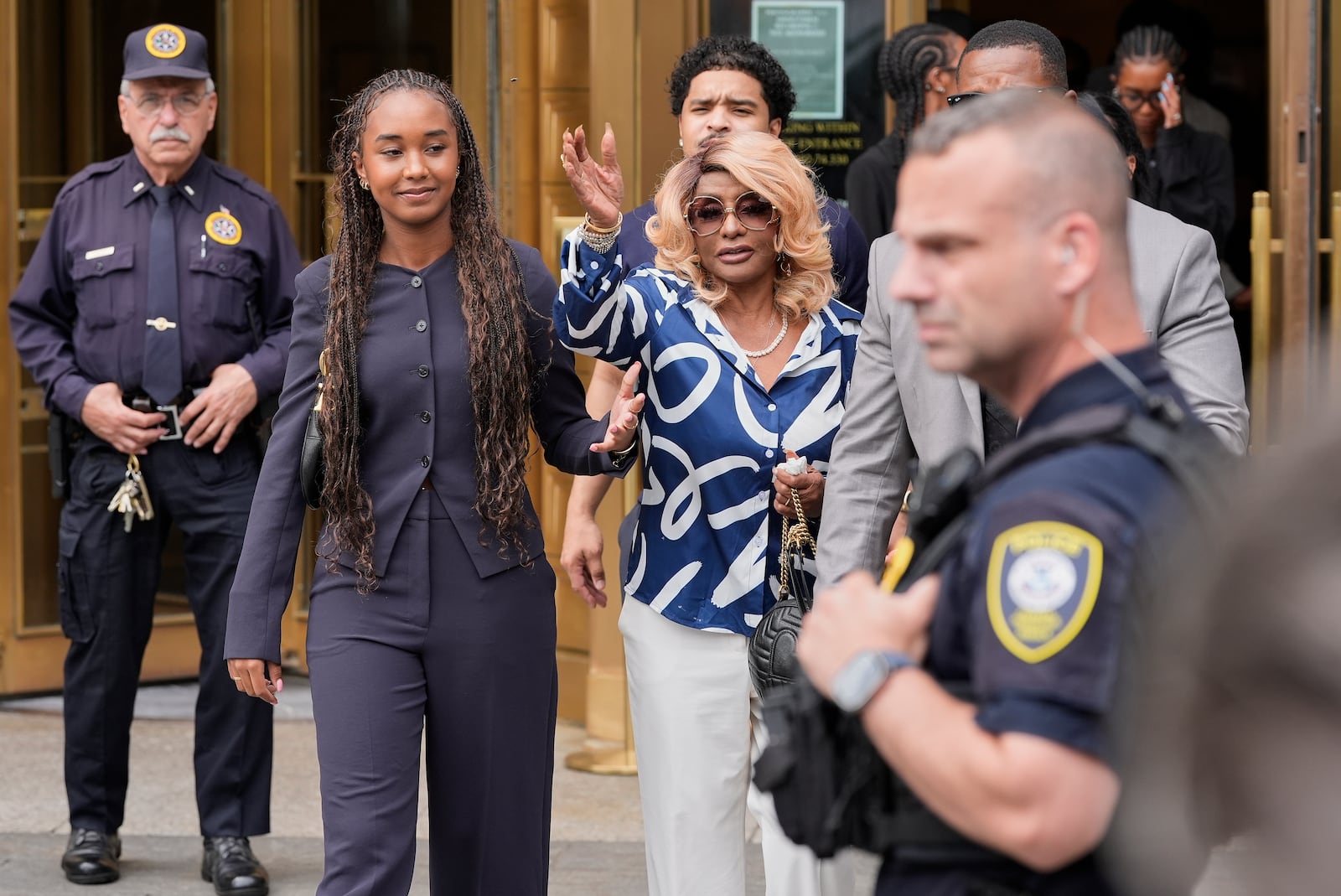 Janice Combs, right, mother of Sean "Diddy" Combs, reacts outside Manhattan federal court after Combs' was convicted of a prostitution-related offense but acquitted on the most serious charges at his New York trial, Wednesday, July 2, 2025, in New York. (AP Photo/Yuki Iwamura)