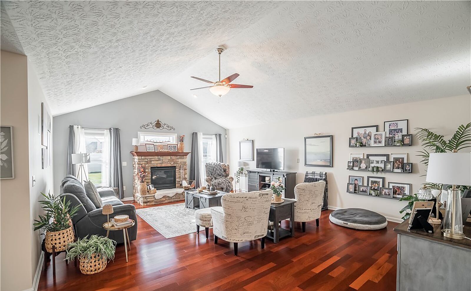 The family room has vaulted ceilings, a gas stacked stone fireplace and hardwood floors. CONTRIBUTED