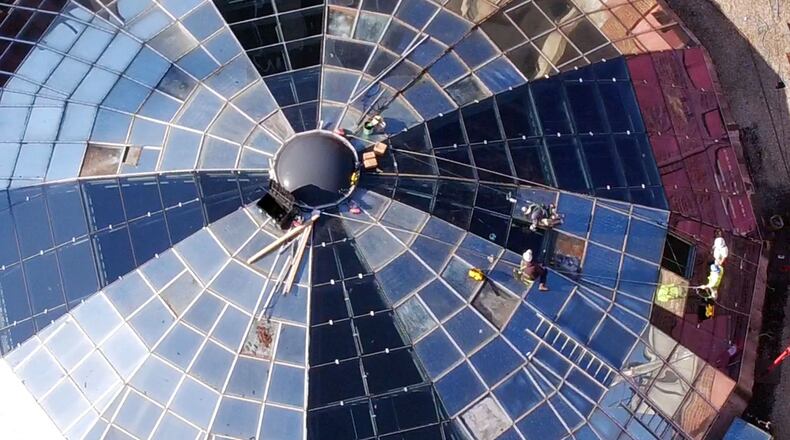 Contractors are replacing the glass panels of the Arcade rotunda dome in downtown Dayton. Developers recently completed financing to close on their planned $90 million overhaul of the massive Dayton Arcade complex. TY GREENLEES / STAFF