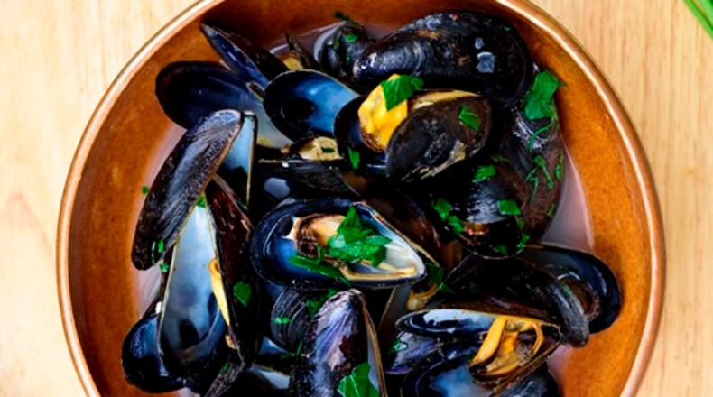 Steamed mussels with garlic and parsley, in New York, Sept. 15, 2015. An easy, tried-and-true dinner solution for last-minute dinner guests requires only a quick stop at the fishmonger for mussels and the baker for baguettes.
