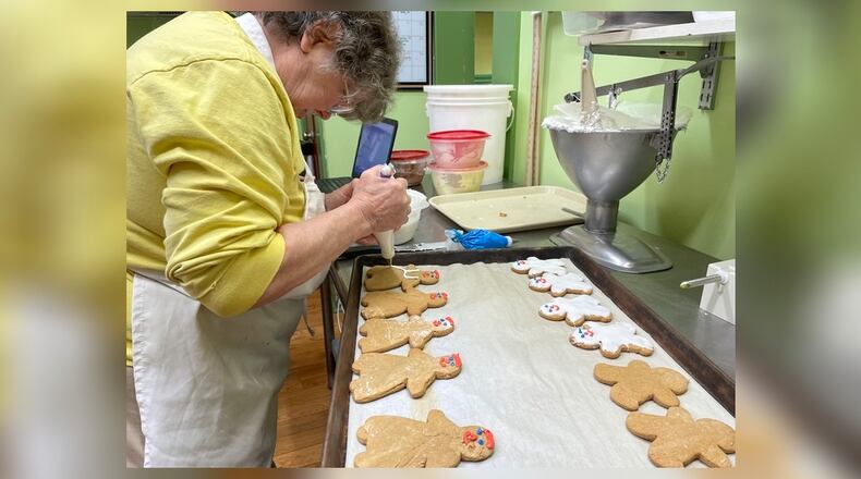 Rosemary Evans decorates gingerbread cookies at Evans Bakery, located at 700 Troy St. in the Old North Dayton neighborhood.