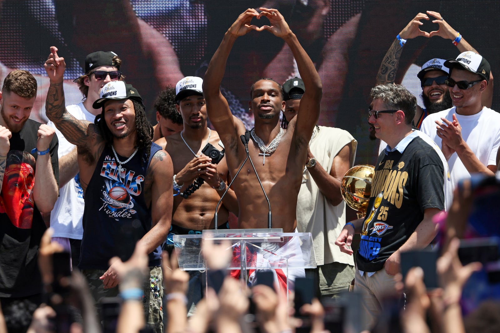 Oklahoma City Thunder guard Shai Gilgeous-Alexander, center, gestures after addressing the crowd during a celebration of the Thunder's NBA basketball championship Tuesday, June 24, 2025, in Oklahoma City. (AP Photo/Nate Billings)