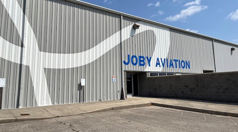 The outside of the former U.S. Postal Service facility near Dayton International Airport sported a new paint job on Tuesday, June 10, 2025 as Joby Aviation prepares the building for occupation. THOMAS GNAU/STAFF