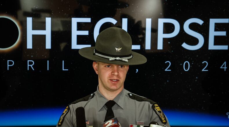 Ohio State Highway Patrol Sgt. Tyler Ross talks to the Dayton and Cincinnati media about being safe on the roads during the April 8 eclipse. JIM NOELKER/STAFF