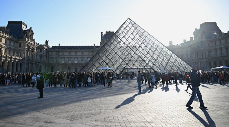 People queue to enter the Louvre museum, Thursday, Oct. 30, 2025 in Paris. (AP Photo/Emma Da Silva)