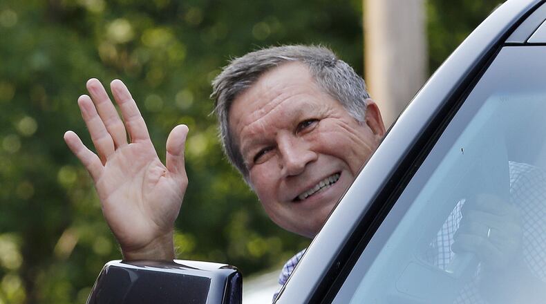 Republican presidential candidate Gov. John Kasich, R-Ohio, waves as he arrives Wednesday for a campaign stop at Robie's Country Store in Hooksett, N.H. The nation's first presidential primary in New Hampshire is less than six months away.