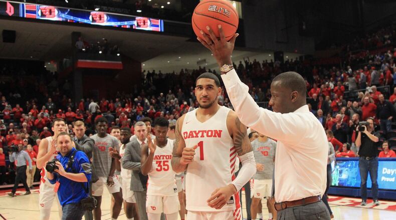Dayton’s Anthony Grant honors Obi Toppin after a game against Duquesne on Saturday, Feb. 23, 2020, at UD Arena. Toppin was honored for scoring his 1,000th point in the game. David Jablonski/Staff