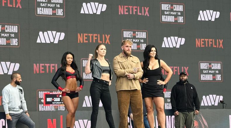 Ronda Rousey, center left, and Gina Carano, right, pose with promoter Jake Paul, center right, during a news conference in Inglewood, Calif., Tuesday, March 10, 2026. (AP Photo/Greg Beacham)