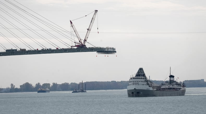 FILE - The Saginaw passes construction on the Gordie Howe International Bridge connecting on the Detroit River connecting Windsor, Ontario and Detroit, Oct. 25, 2023. (AP Photo/Paul Sancya, File)