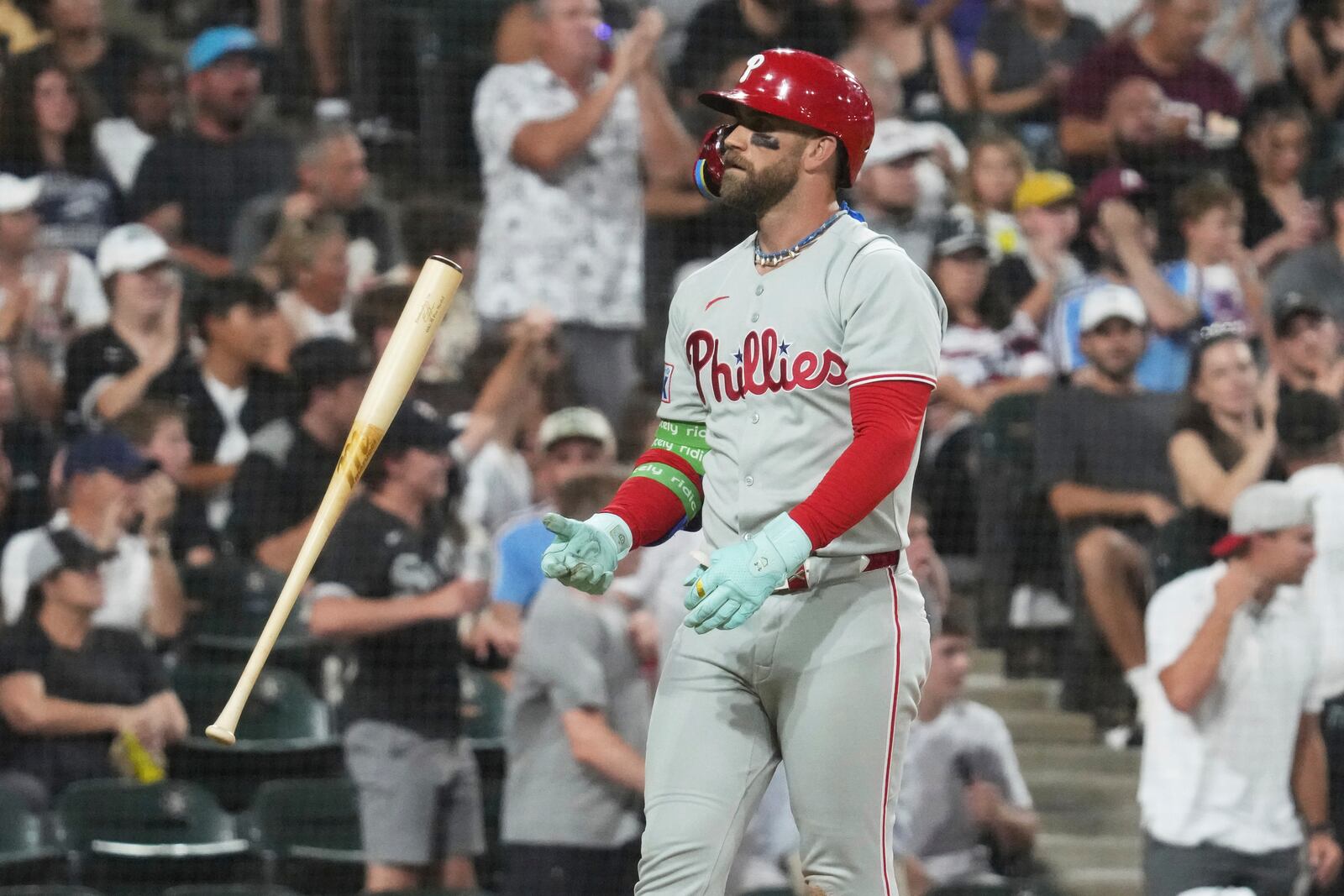 Philadelphia Phillies' Bryce Harper flips his bat as he pops out to Chicago White Sox third baseman Colson Montgomery in foul territory during the seventh inning of a baseball game in Chicago, Monday, July 28, 2025. (AP Photo/Nam Y. Huh)