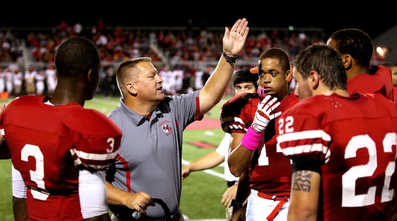 Lakota West coach Larry Cox talks with his team during the Firebirds’ 35-3 win over visiting Fairfield on Oct. 11, 2013. JOURNAL-NEWS FILE PHOTO