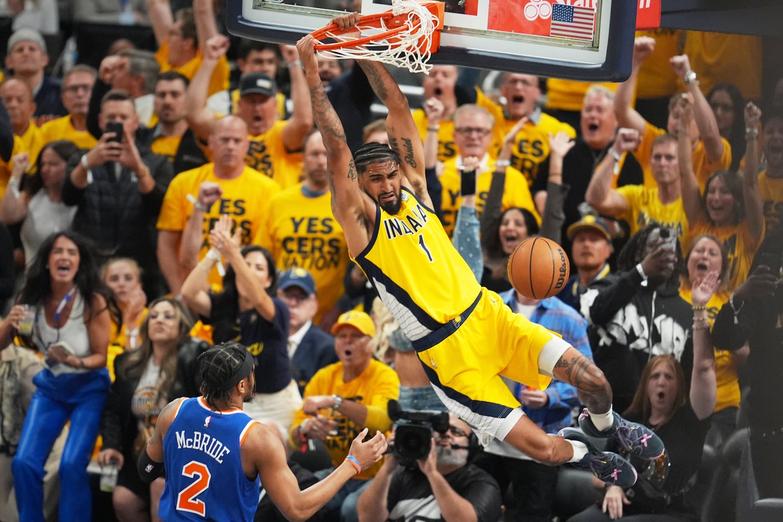 Indiana Pacers forward Obi Toppin (1) dunks the ball over New York Knicks guard Miles McBride (2) during the first half of Game 4 of the Eastern Conference finals of the NBA basketball playoffs in Indianapolis, Tuesday, May 27, 2025. (AP Photo/Michael Conroy)