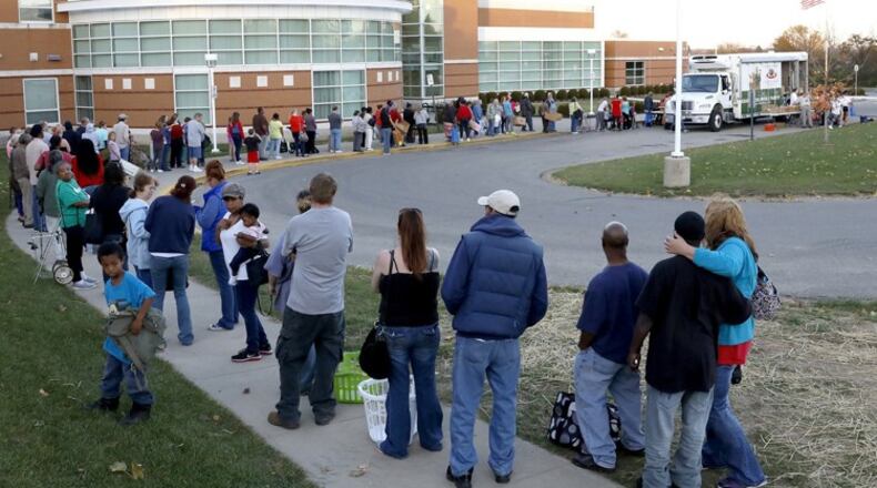 A line of people waiting for the Mobile Food Pantry wraps around part of the parking lot at Clark School in November. Bill Lackey/Staff