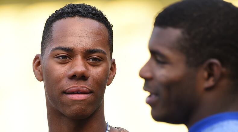 LOS ANGELES, CA - APRIL 28: High School baseball player Hunter Greene, from Stevenson Ranch, CA, the possible first overall pick in the 2017 MLB draft, talks with Yasiel Puig #66 of the Los Angeles Dodgers during batting practice before the game against the Philadelphia Phillies at Dodger Stadium on April 28, 2017 in Los Angeles, California. (Photo by Jayne Kamin-Oncea/Getty Images)