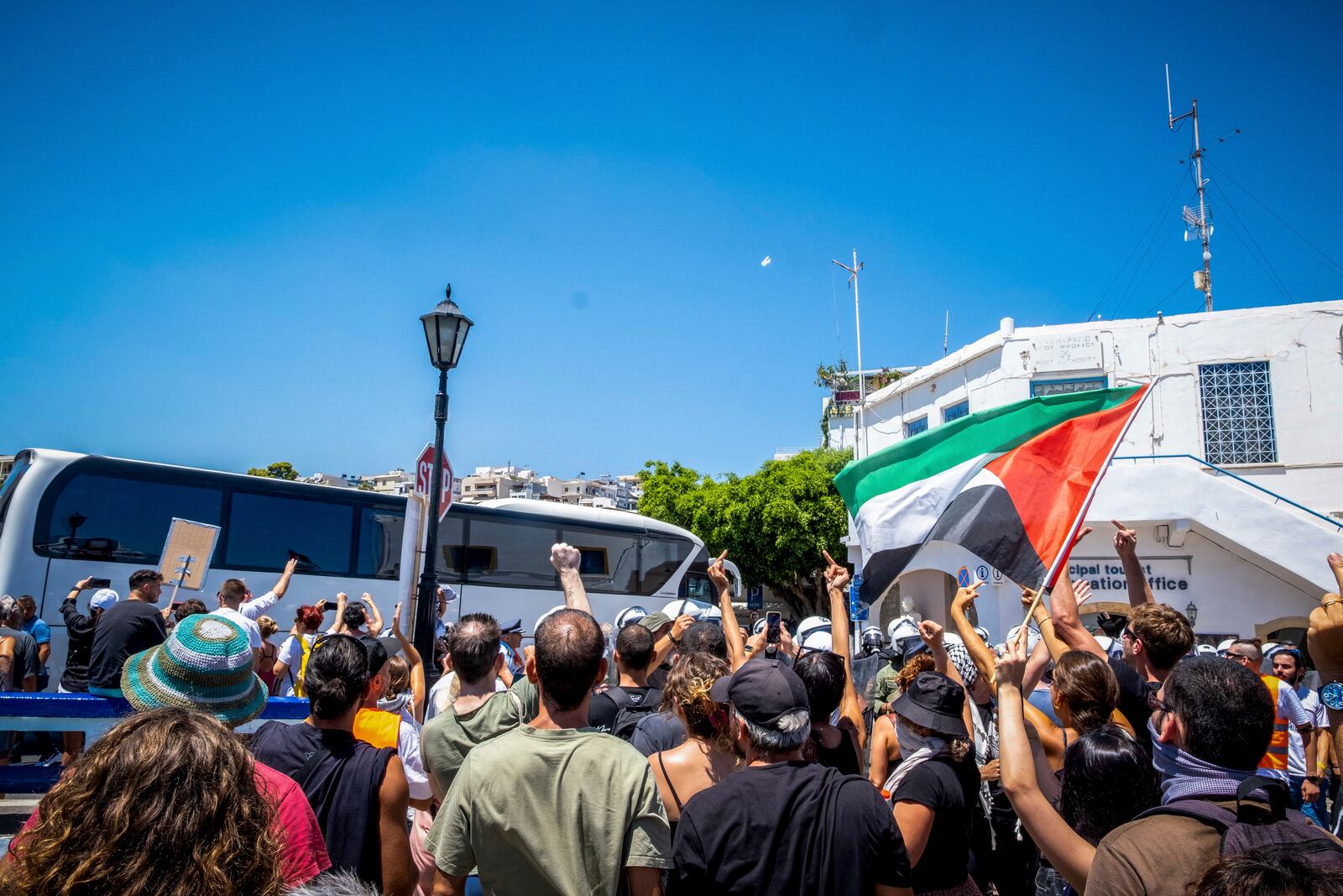 EDS NOTE: OBSCENITY - Pro-Palestinian protesters react as a coach carrying Israeli tourists leave the port after the arrival of a cruise ship, in Agios Nikolaos, on the island of Crete, Greece, Tuesday, July 29, 2025. (Antonis Zouridakis/Eurokinissi via AP)