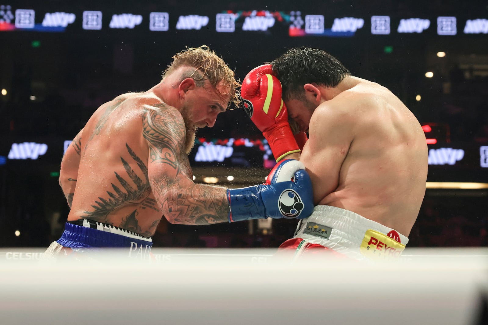 Jake Paul, left, punches Julio Cesar Chavez Jr. during their cruiserweight boxing match on Saturday, June 28, 2025, in Anaheim, Calif. (AP Photo/Etienne Laurent)