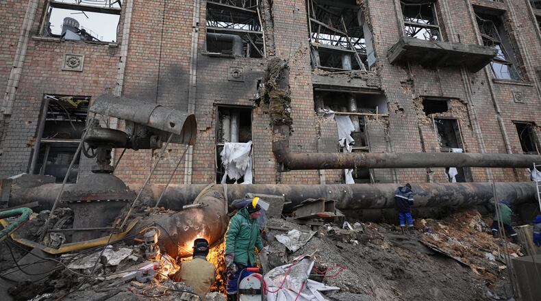 Workers clean up damage at Darnytsia Thermal Power Plant after a Russian attack in Kyiv, Ukraine, Wednesday, Feb. 4, 2026. (AP Photo/Sergei Grits)
