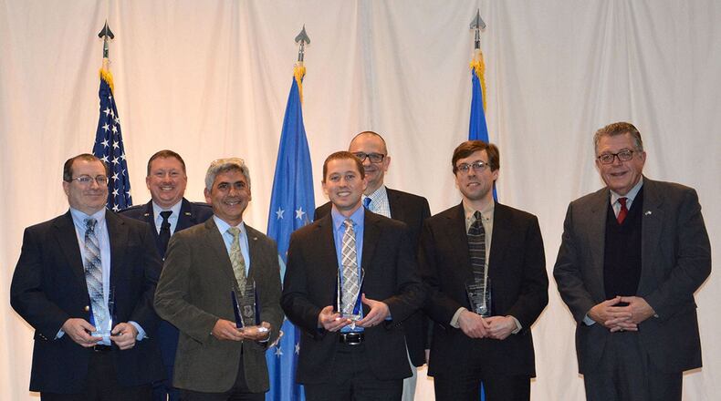 Michael Cleary presented the directorate’s most prestigious award, the Charles J. Cleary Scientific Achievement Award, to the Flexible Gallium Nitride for High Performance, Strainable Radio Frequency Devices Team at the 65th annual Materials and Manufacturing Directorate Awards Luncheon. Shown left to right: Dr. Donald Dorsey, Col. Charles Ormsby, Dr. Benji Maruyama, Dr. Nicholas Glavin, Dr. Timothy Bunning, Dr. Eric Heller and Michael Cleary. (U.S. Air Force photo/Karen Schlesinger)