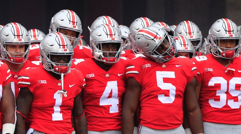 Ohio State players, including Johnnie Dixon (1), Jordan Fuller (4), Baron Browning (5) and Malik Harrison (39), prepare to take the field before a game against Rutgers on Saturday, Sept. 8, 2018, at Ohio Stadium in Columbus. David Jablonski/Staff