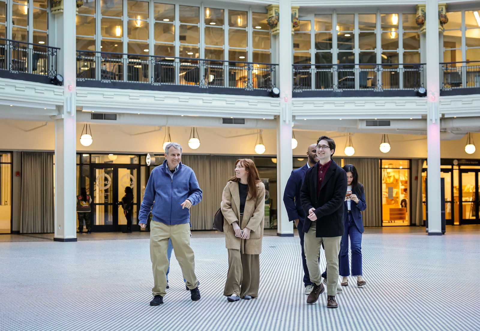 Former Sen. Sherrod Brown (far left) walks with a group during a tour of Dayton Arcade on Wednesday, Feb. 11. Brown visited the 6888 Kitchen Incubator, which he requested funding for through an earmark in 2022. BRYANT BILLING / STAFF