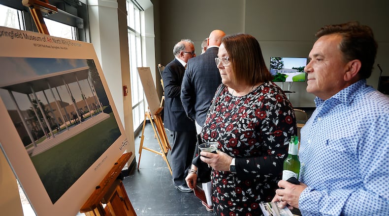 Alicia and Greg Hupp look over the artist's renderings showing what the renovated North Wing of the Springfield Museum of Art will look like following a ribbon cutting ceremony and reception celebrating the start of the multi-million dollar project Thursday, March 23, 2023. BILL LACKEY/STAFF