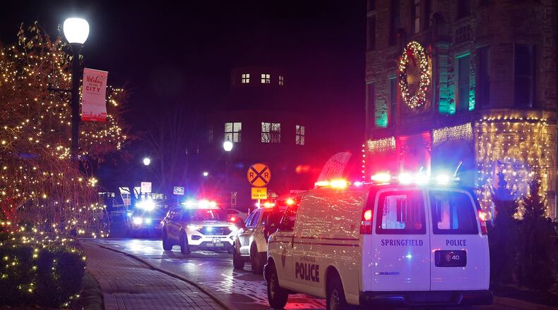 Springfield police investigate the scene of a shooting in the parking lot of the Clark County Heritage Center Friday, Nov. 25, 2022 following the Holiday in the City kickoff. BILL LACKEY/STAFF
