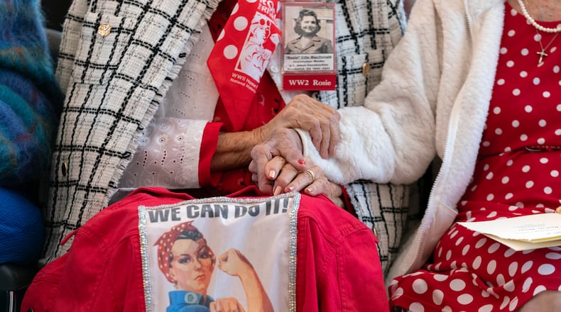 "Rosie the Riveters" Lucille "Cille" MacDonald, left, and Delphine Kaput, hold hands during a Congressional Gold Medal Ceremony in honor of the World War II factory workers, on Capitol Hill in Washington, April 10, 2024. “Rosie the Riveter,” is a catchall referencing the women who flooded factories and shipyards during World War II to build planes, ships, and bombs. (AP Photo/Jose Luis Magana)