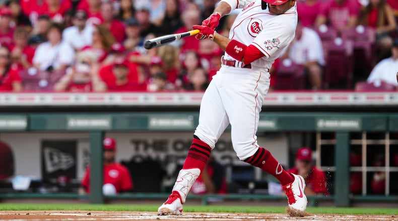Cincinnati Reds' Joey Votto hits a two-run home run against the Baltimore Orioles during the first inning of a baseball game Friday, July 29, 2022, in Cincinnati. (AP Photo/Jeff Dean)