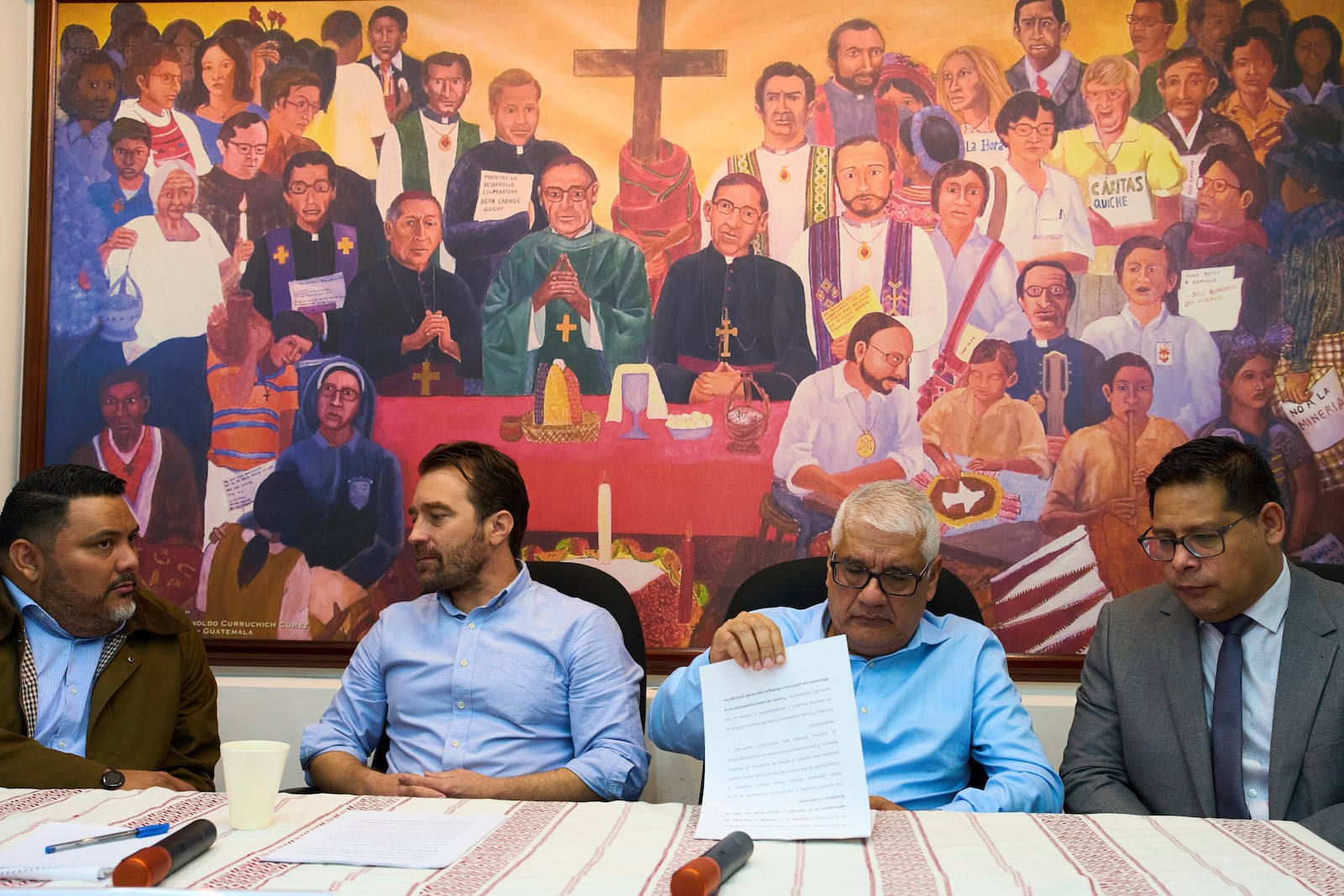 Members of the human rights organization Cristosal, from left, Rene Valiente, Noah Bullock, Abraham Abrego and Rafael Cruz, sit moments before giving their press conference in Guatemala City, Thursday, July 17, 2025, to announce that Cristosal is suspending their activities in El Salvador. (AP Photo/Moises Castillo)