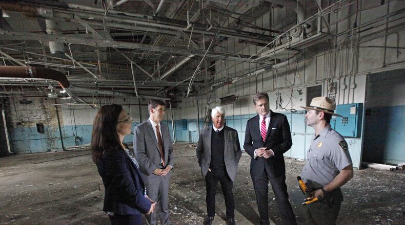 Dayton Aviation Heritage National Historical Park Superintendent Kendell Thompson, right, talks about the preservation of the first airplane factory with Congressmen Mike Turner and Chairman Rob Bishop of the House Committee on Natural Resources along with Dayton History President & CEO Brady Kress, and National Aviation Heritage Area Executive Director Mackensie Wittmer, left, at the Wright Company Factory on Wednesday. The Congressmen spoke about efforts to support National Parks and history in the Dayton region. TY GREENLEES / STAFF