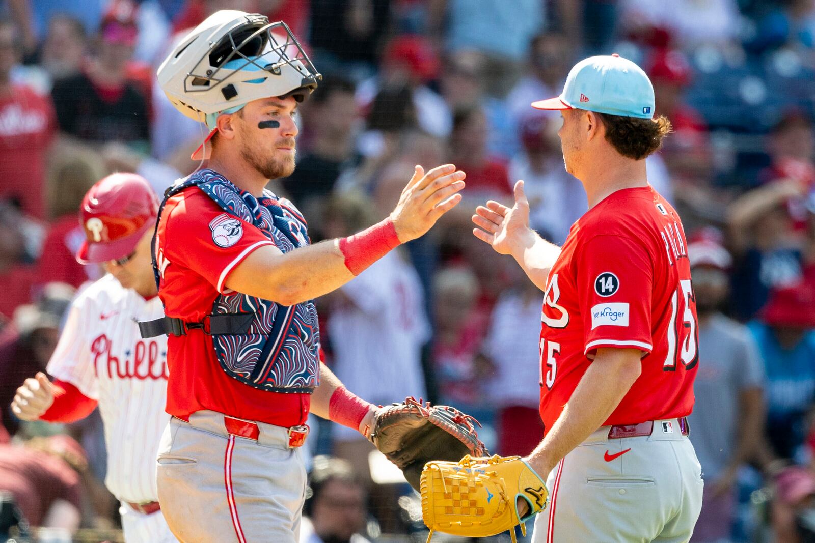 Cincinnati Reds catcher Tyler Stephenson, left, and closing pitcher Emilio Pagan (15) celebrate after their win over the Philadelphia Phillies in a baseball game, Friday, July 4, 2025, in Philadelphia. (AP Photo/Laurence Kesterson)