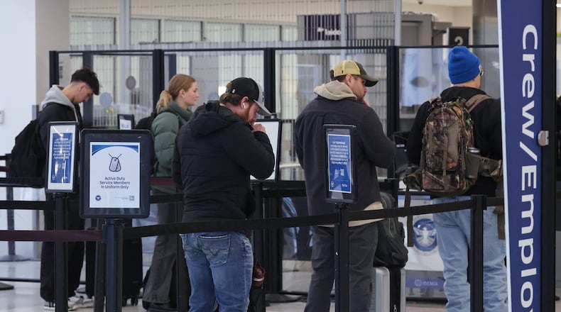 Passengers wait in a Transportation Security Administration security line at James M. Cox Dayton International Airport on Thursday, Dec. 11. BRYANT BILLING/STAFF