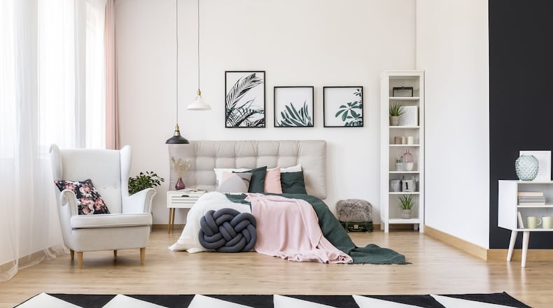 A mix of bold patterns, moody colors and nature-inspired accents makes this bedroom perfectly on trend. (Dreamstime)