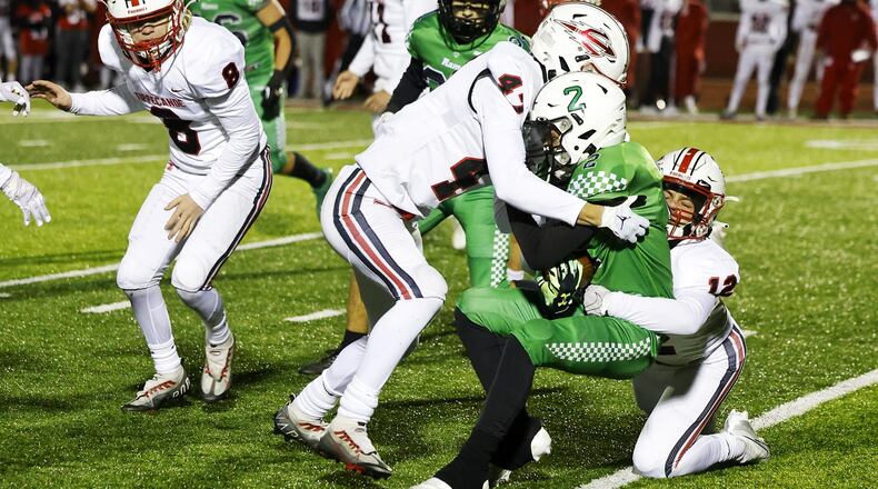 Badin's Connor Wright is tackled by Tippecanoe's Lukas Walker (47) and Ethan Henderson (12) during a 20-17 loss to Tippecanoe in their Division III Regional Final football game Friday, Nov. 18, 2022 at Trotwood-Madison High School. NICK GRAHAM/STAFF