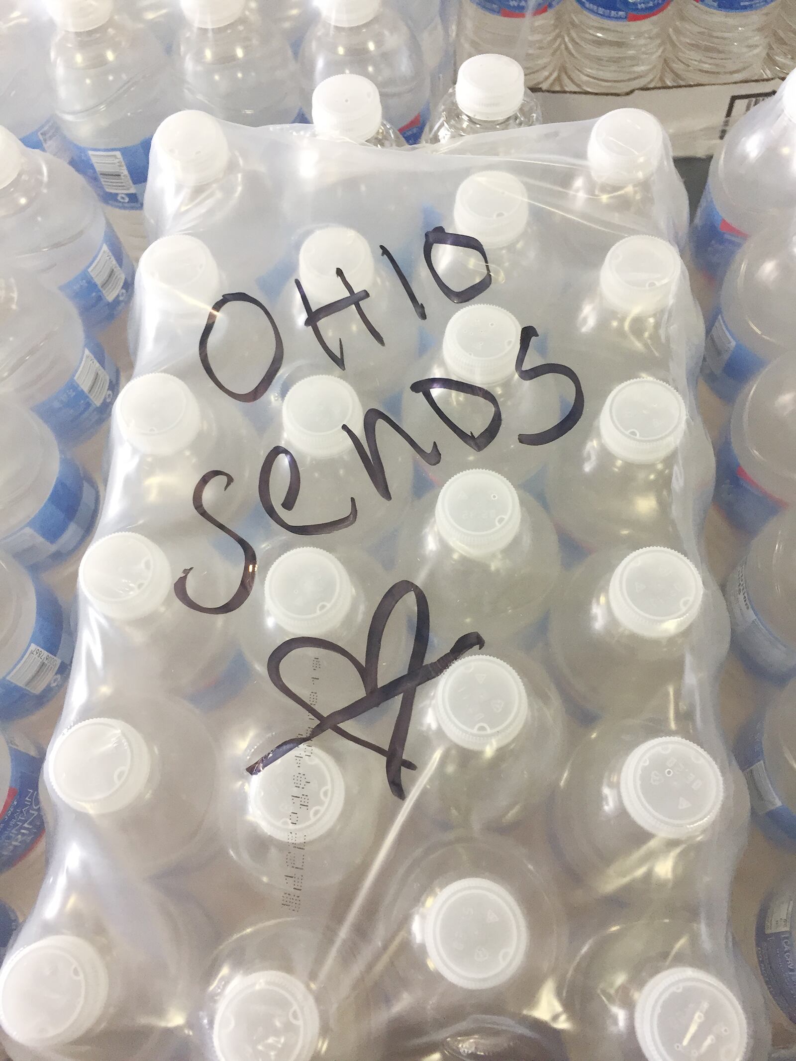 Messages have been left at The Foodbank in Dayton on donated cases of water and pallets bound to victims of Harvey in Texas. SUBMITTED