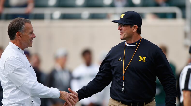 EAST LANSING, MI - OCTOBER 29: Head coach Jim Harbaugh Michigan Wolverines shakes hands with head coach Mark Dantonio of the Michigan State Spartans prior to the game at Spartan Stadium on October 29, 2016 in East Lansing, Michigan. (Photo by Gregory Shamus/Getty Images)