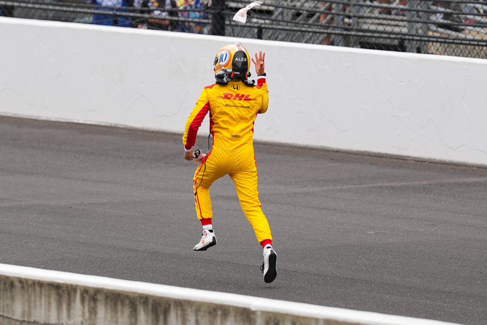 Alex Palou, of Spain, runs down the track as he celebrates after winning the Indianapolis 500 auto race at Indianapolis Motor Speedway in Indianapolis, Sunday, May 25, 2025. (AP Photo/Michael Conroy)