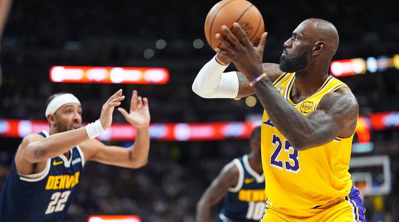 Los Angeles Lakers forward LeBron James, right, goes up for a field goal to surpass Kareem Abdul-Jabbar's record of 15,837 to become the NBA's all-time leader in field goals as Denver Nuggets forward Zeke Nnaji defendns in the first half of an NBA basketball game Thursday, March 5, 2026, in Denver. (AP Photo/David Zalubowski)