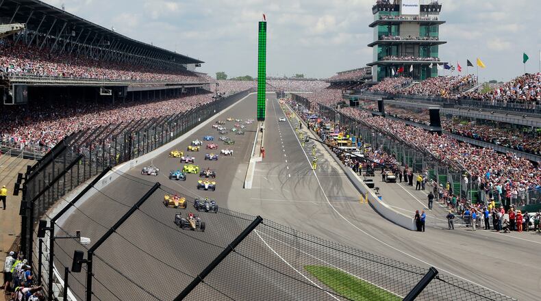 FILE - In this May 29, 2016, file photo, James Hinchcliffe, of Canada, leads the field into the first turn on the start of the 100th running of the Indianapolis 500 auto race at Indianapolis Motor Speedway in Indianapolis. Indianapolis Motor Speedway president Doug Boles had a very real fear following last year’s 100th edition of the Indy 500: That many in the record-setting crowd packing his track last May would decide to be “101 and done.” Instead, the milestone appears to have given the Greatest Spectacle in Racing a lasting bump heading into next weekend’s running. (AP Photo/R Brent Smith, File)
