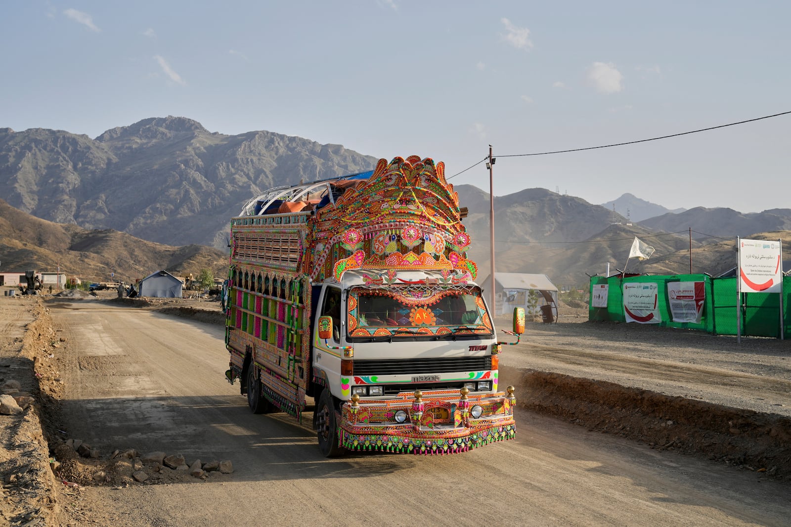 A Pakistani truck carrying repatriated Afghan refugees arrives at a camp near the Pakistan-Afghanistan border, in Torkham, Afghanistan, Saturday, May 31, 2025. (AP Photo/Ebrahim Noroozi)
