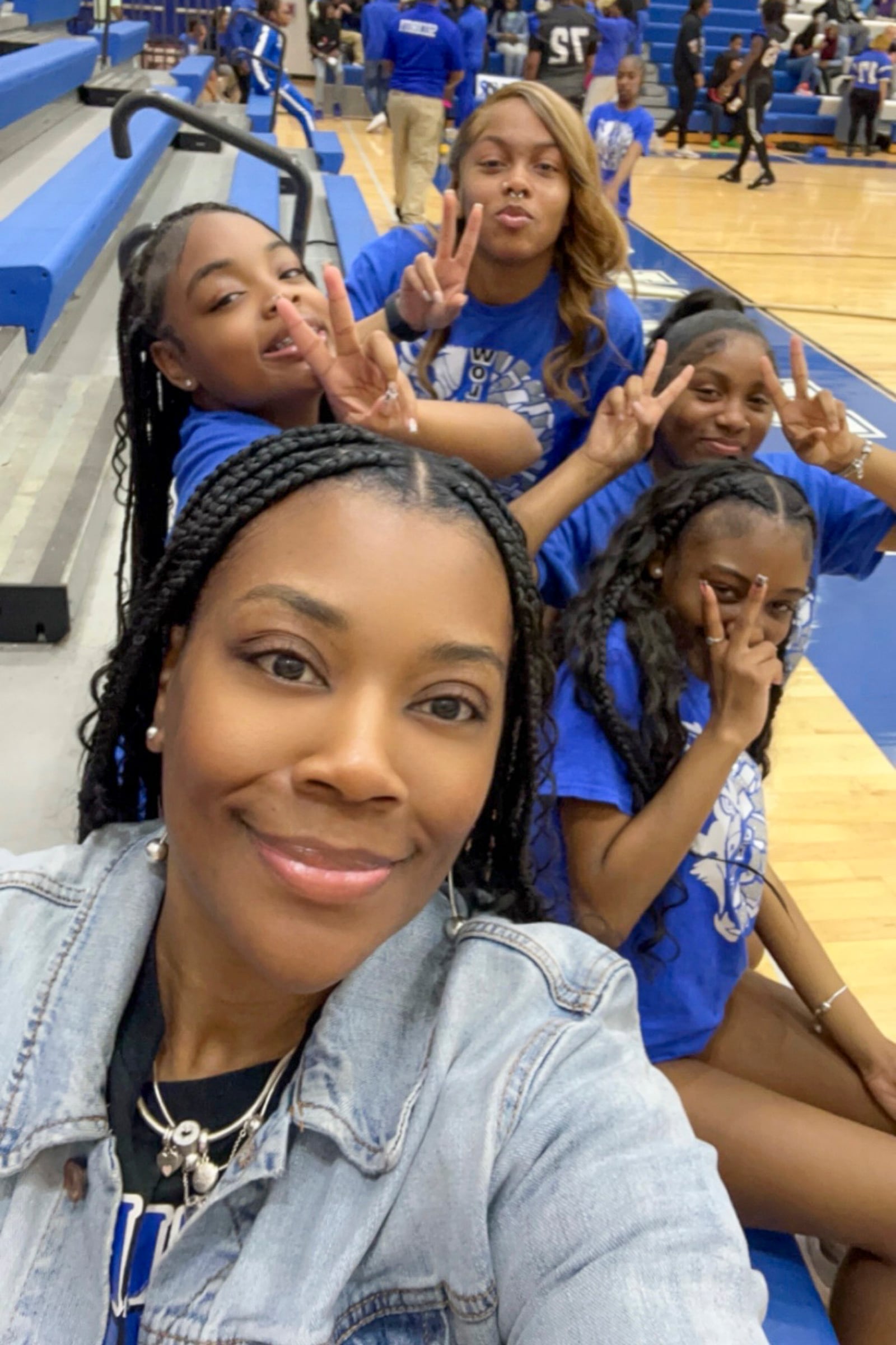 Dunbar coach Juanida Hurt poses for a photo with her cheerleading squad during a recent basketball game. CONTRIBUTED PHOTO