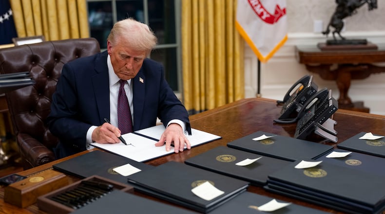 President Donald Trump signs executive orders in the Oval Office of the White House in Washington on Monday, Jan. 20, 2025, following his inauguration as the 47th president. During his first week in office, President Trump issued a barrage of executive orders, signing sweeping directives on immigration, D.E.I., energy policy, trade, TikTok and more. (Doug Mills/The New York Times)