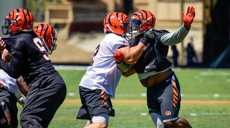 Cincinnati Bengals guard Alex Redmond, left, blocks defensive tackle Brandon Thompson during practice Tuesday, June 6 on their practice fields next to Paul Brown Stadium in Cincinnati. NICK GRAHAM/STAFF