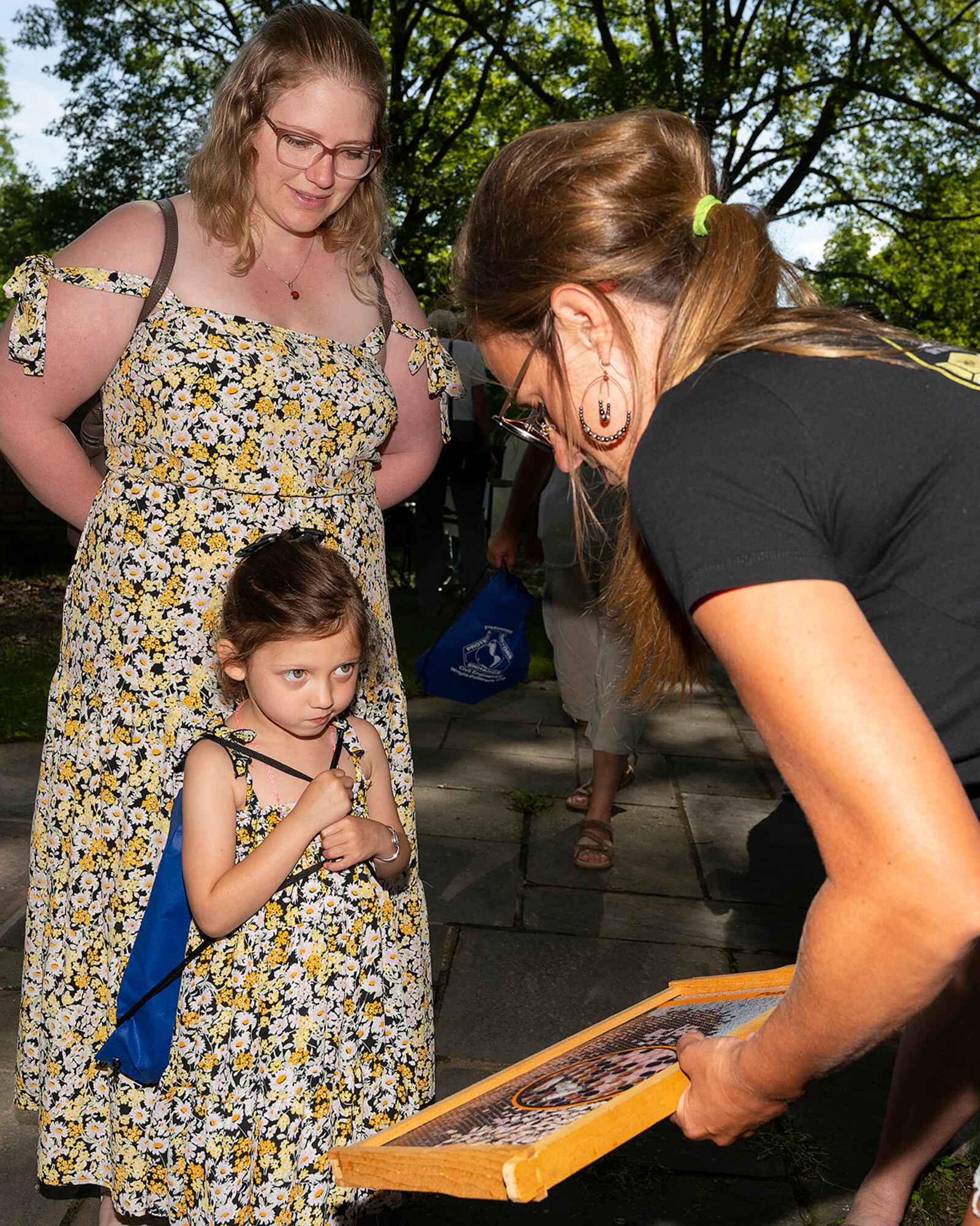 Lilly Yu Blythe, 4, seems doubtful as she listens to Maddie Mullins, Blue Collar Honeybees, explains how honey is made during the annual Wright-Patterson Air Force Base Pollinator Expo on June 8 at the Wright Brothers monument. Lilly was brought to the expo by her mother, Samantha Yu Blythe, who is an environmental science teacher at Miamisburg High School. U.S. AIR FORCE PHOTO/R.J. ORIEZ