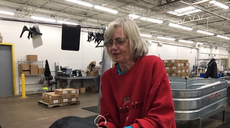 Riverside resident Cindy Baker, a Lion Apparel tester and sewing operator, at work at Lion’s Janney Road facility. Lion is rebuilding and hiring new workers after suffering damage in the Memorial Day tornadoes. THOMAS GNAU/STAFF