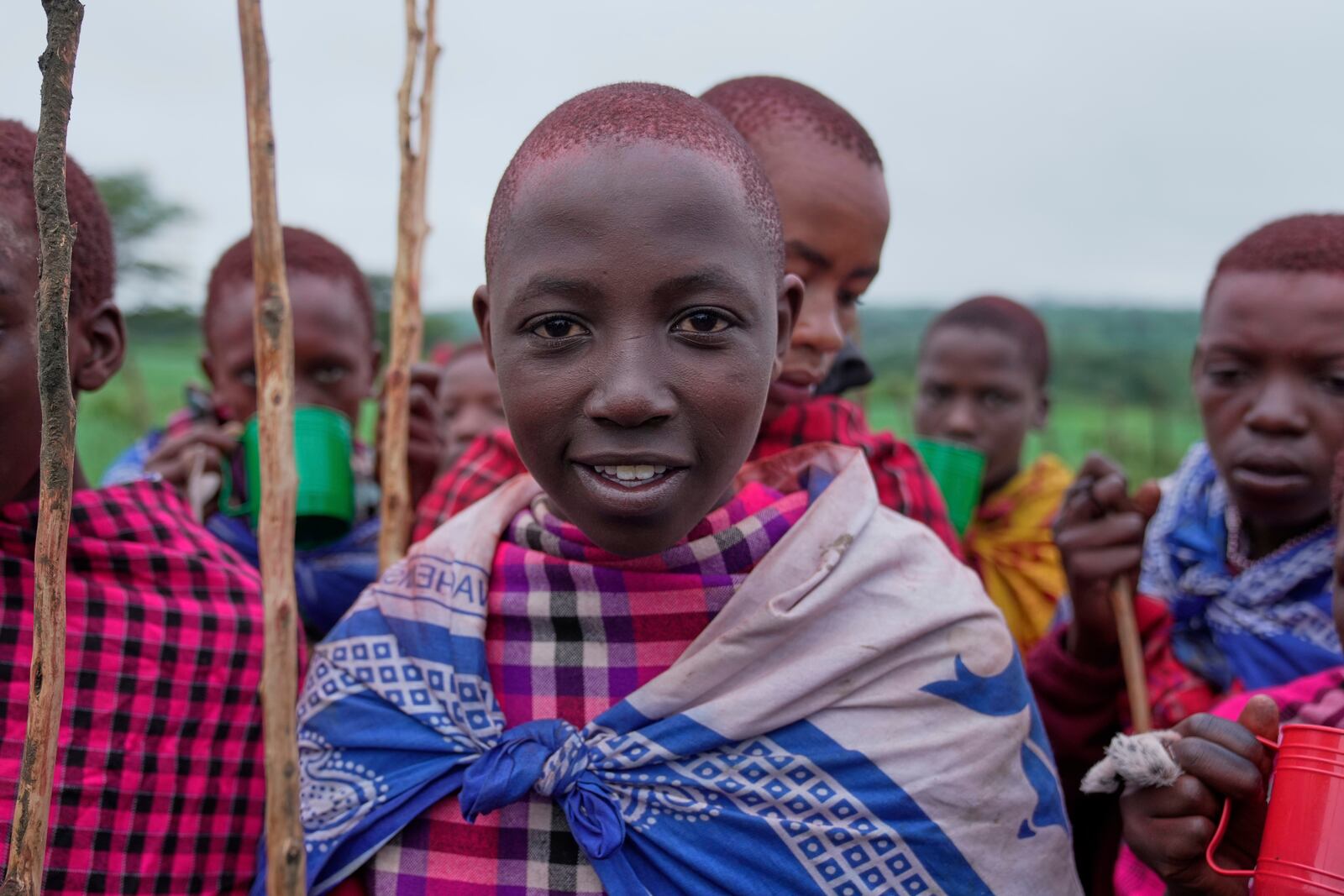 Isaac Mpusia, 16 years old, of the Maasai tribe poses for a photo, during the Enkipaata ceremony, a Maasai male rite of passage, specifically the initiation of boys, marking the transition from childhood to becoming a moran (warrior) in Olaimutiai, Narok County, Kenya Thursday, April 24, 2024. (AP Photo/Brian Inganga)